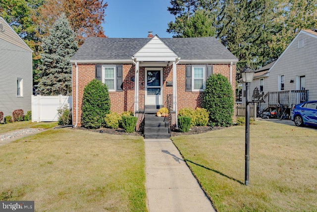 bungalow-style home with a front yard