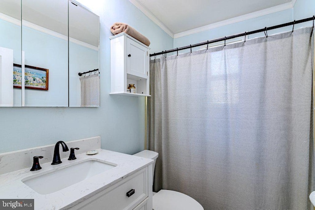 bathroom with vanity, toilet, and crown molding