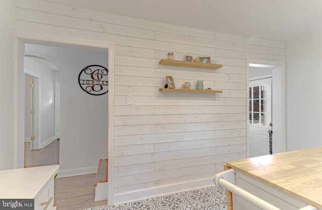 interior space featuring hardwood / wood-style flooring and wooden walls