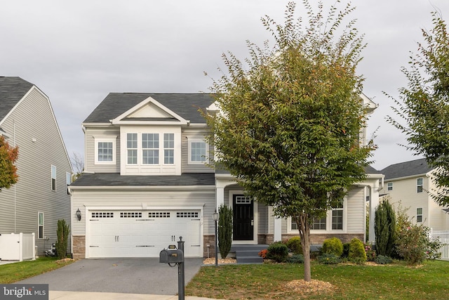 view of front of property featuring a front yard and a garage