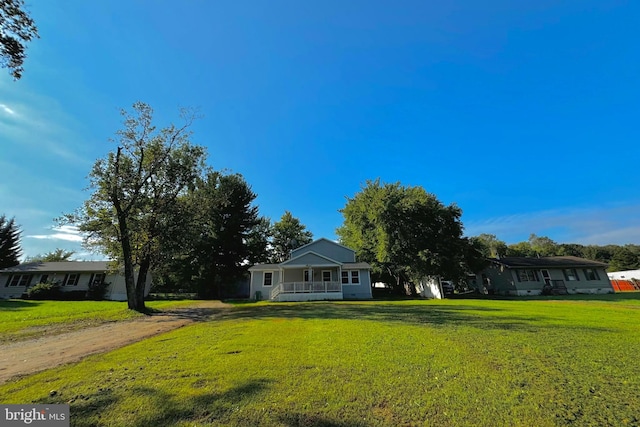 view of front facade with a front yard and a porch