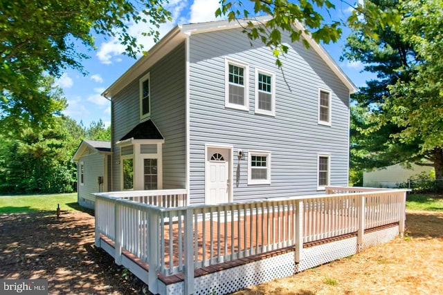 back of house featuring a wooden deck