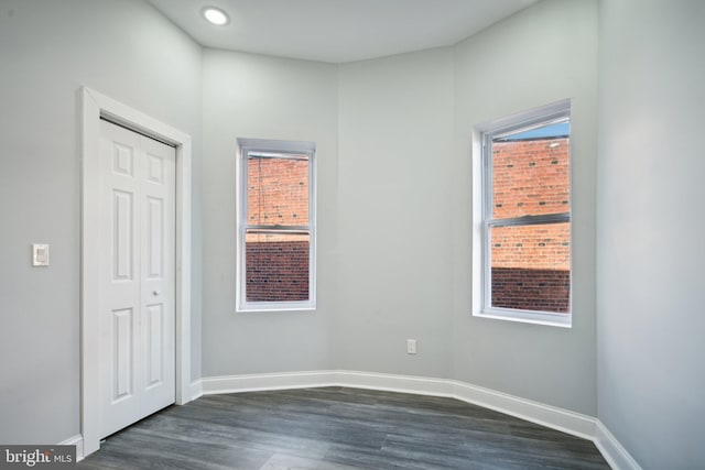 spare room featuring dark wood-type flooring