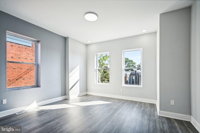 unfurnished room with dark wood-type flooring