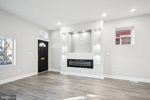 unfurnished living room with wood-type flooring