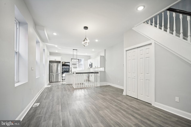 unfurnished living room featuring dark hardwood / wood-style flooring