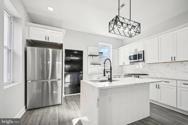 kitchen with white cabinetry, sink, and stainless steel appliances