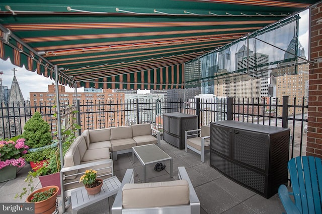 view of patio featuring outdoor lounge area and a balcony