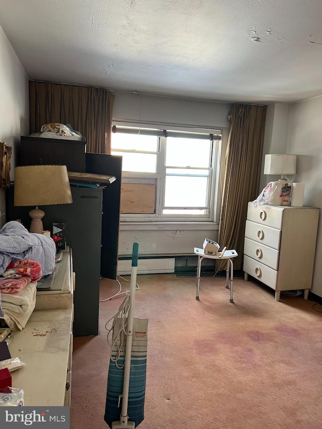 bedroom with carpet floors, a baseboard radiator, and a textured ceiling