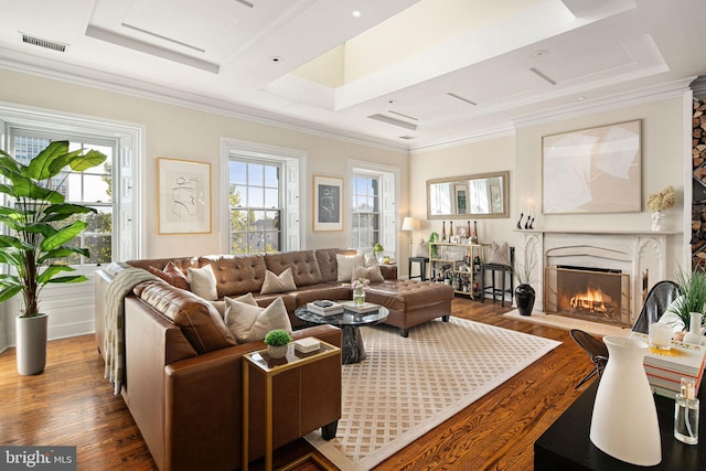 living room with a premium fireplace, crown molding, and dark hardwood / wood-style flooring