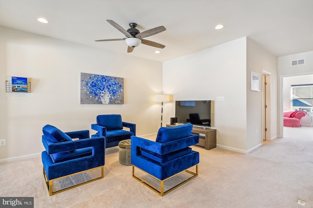 living room featuring light carpet and ceiling fan