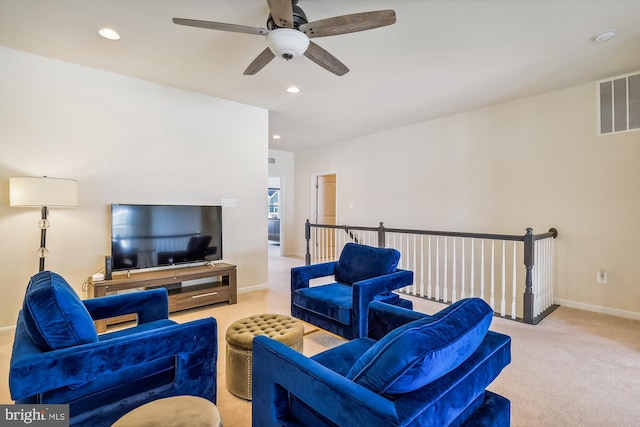 carpeted living room with ceiling fan