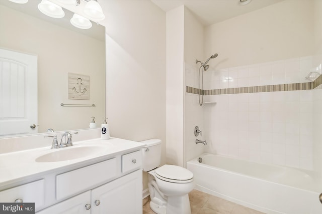 full bathroom featuring tiled shower / bath, vanity, toilet, and tile patterned floors