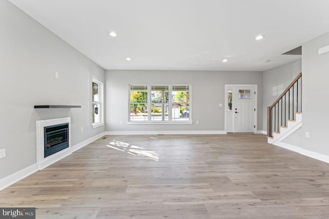 unfurnished living room with light wood-type flooring