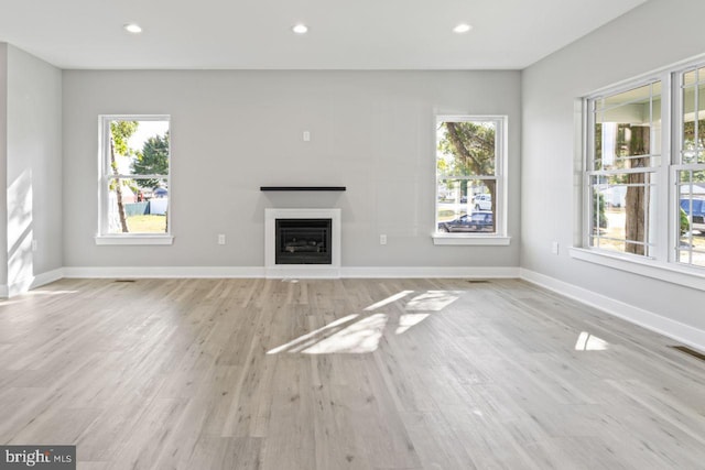 unfurnished living room with light wood-type flooring