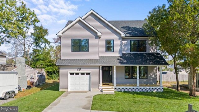 view of front of property with covered porch, a garage, and a front lawn