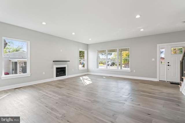 unfurnished living room featuring light hardwood / wood-style floors