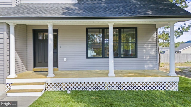 view of exterior entry featuring covered porch