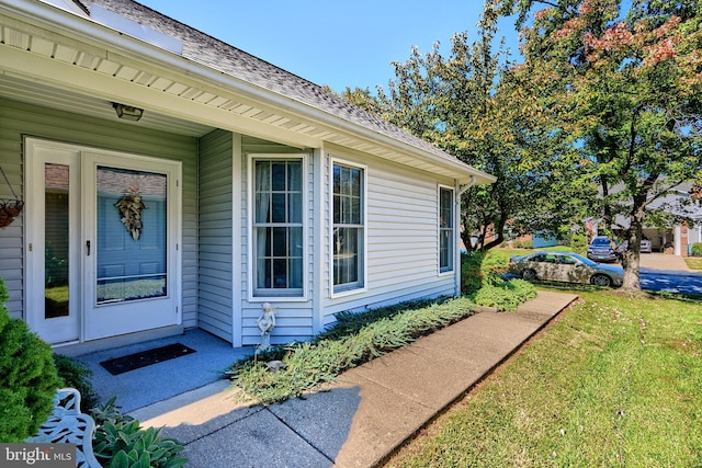 doorway to property featuring a yard