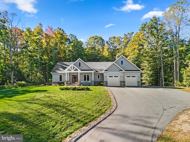 craftsman-style home featuring a front yard and a garage