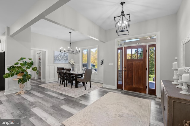 foyer entrance with a notable chandelier and hardwood / wood-style floors