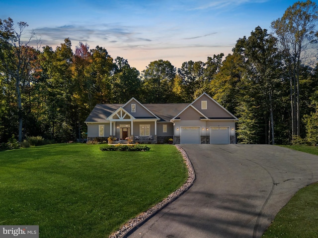 view of front of property with a yard and a garage