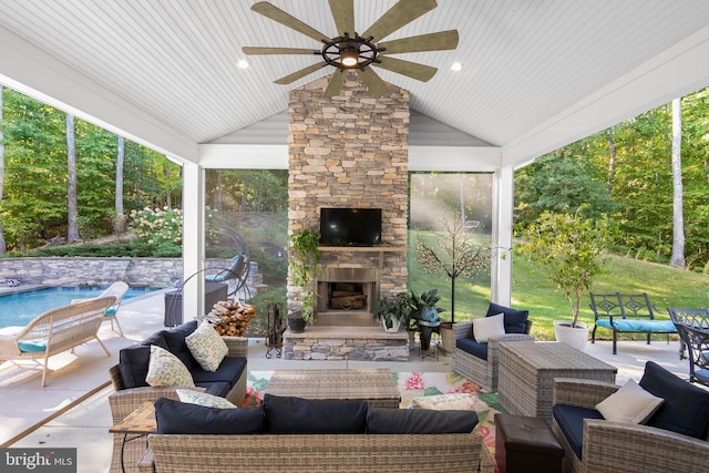 view of patio / terrace featuring an outdoor living space with a fireplace and ceiling fan