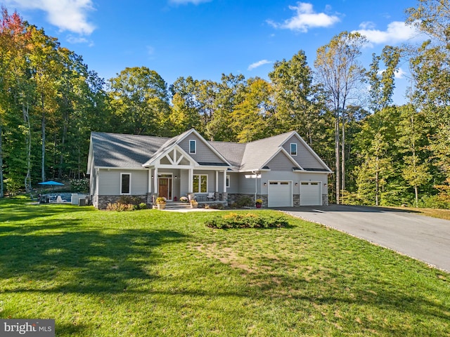 craftsman-style house with cooling unit, a front lawn, covered porch, and a garage