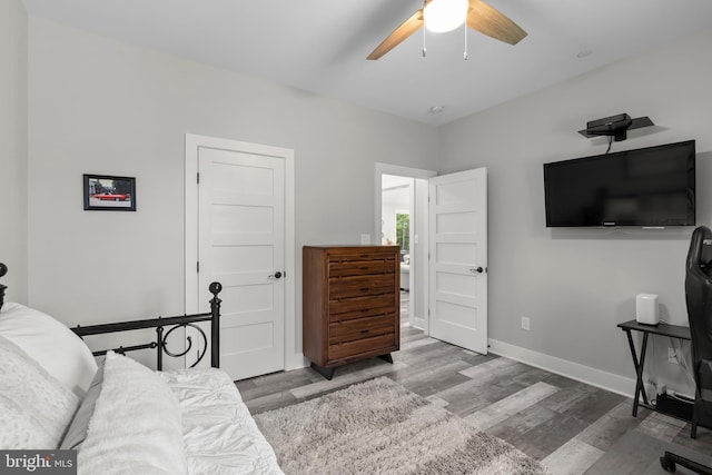 bedroom with hardwood / wood-style floors and ceiling fan