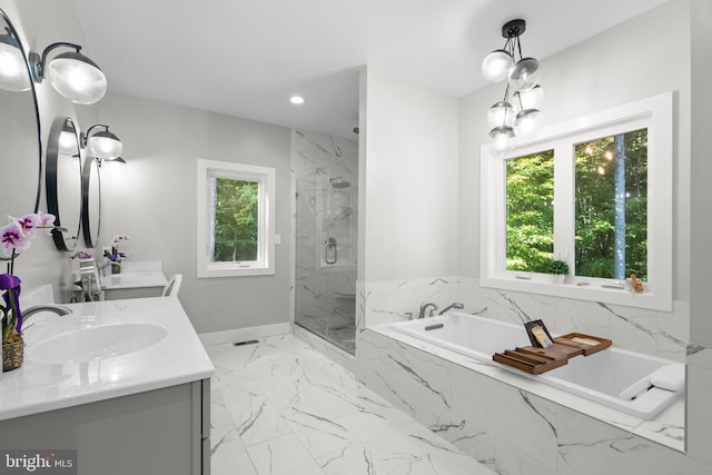 bathroom with vanity and separate shower and tub