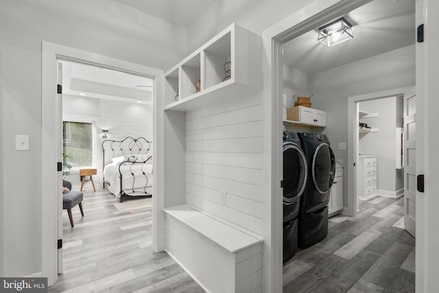 mudroom with light hardwood / wood-style flooring and washer and dryer