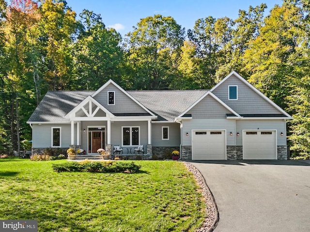 craftsman-style house featuring a garage, a front lawn, and a porch