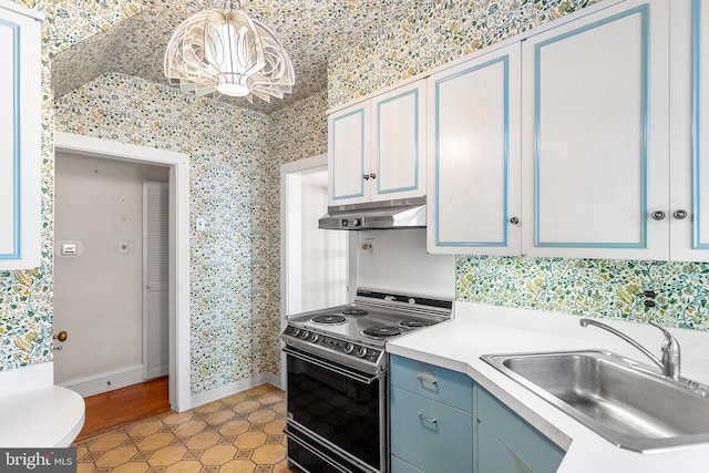 kitchen featuring blue cabinets, a chandelier, black stove, sink, and hanging light fixtures