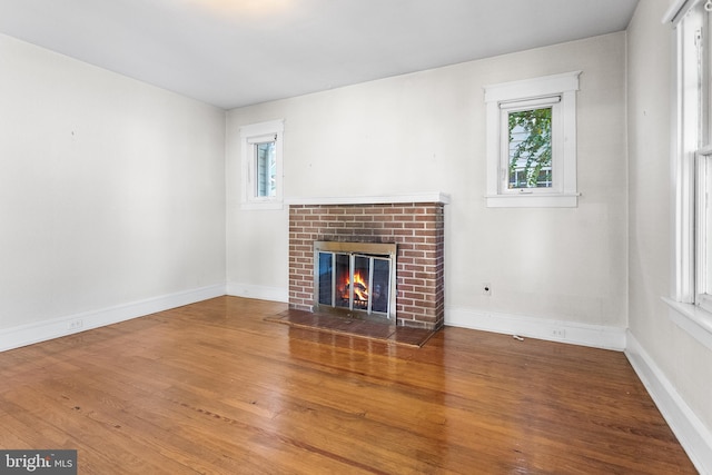 unfurnished living room featuring a fireplace and wood-type flooring