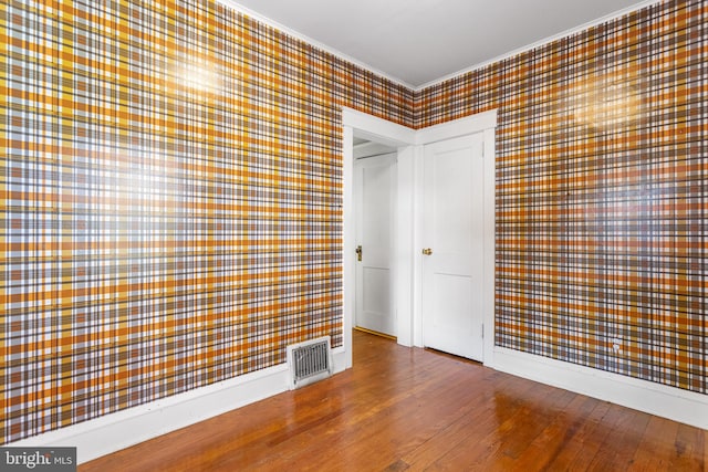 interior space featuring wood-type flooring and ornamental molding