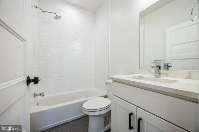 full bathroom featuring vanity, tiled shower / bath combo, toilet, and tile patterned flooring