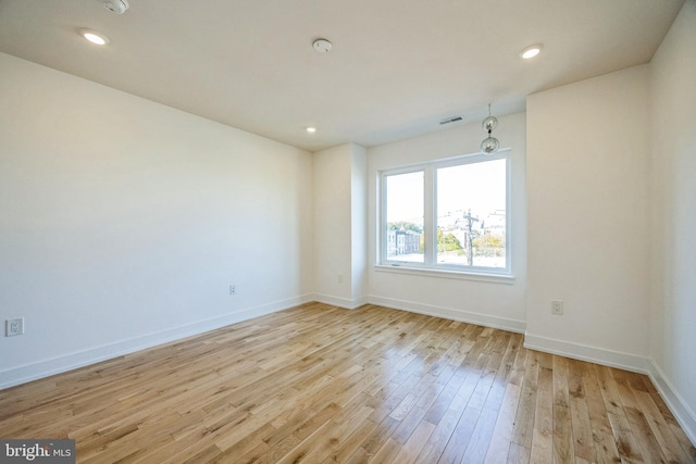 unfurnished room with light hardwood / wood-style floors