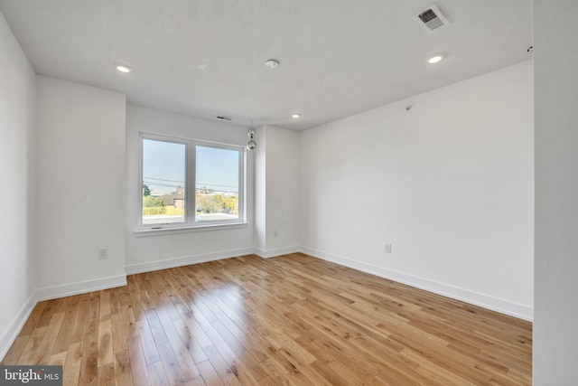 spare room with light hardwood / wood-style flooring