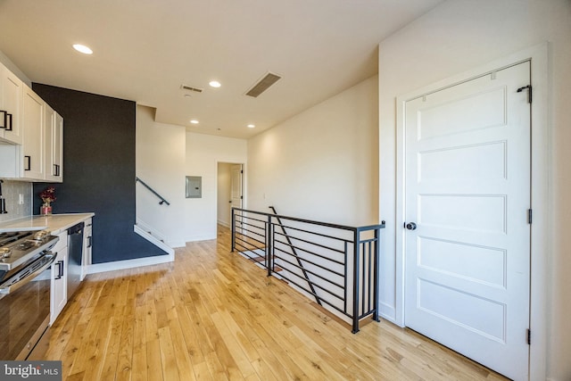 614 W Master St Unit 2, Philadelphia, PA 19122 - kitchen with light wood-style floors, appliances with stainless steel finishes, light countertops, white cabinets, and electric panel