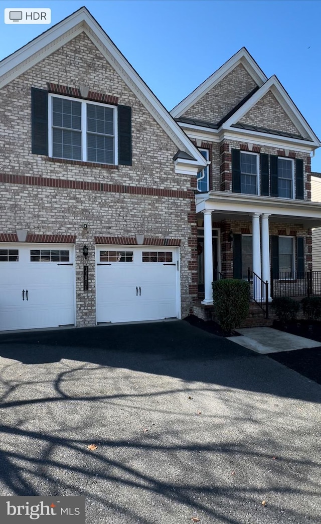 view of front property with a garage and a porch