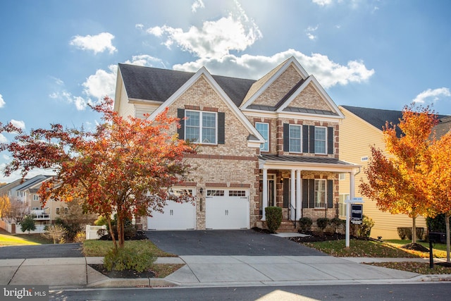 craftsman inspired home featuring a garage and covered porch