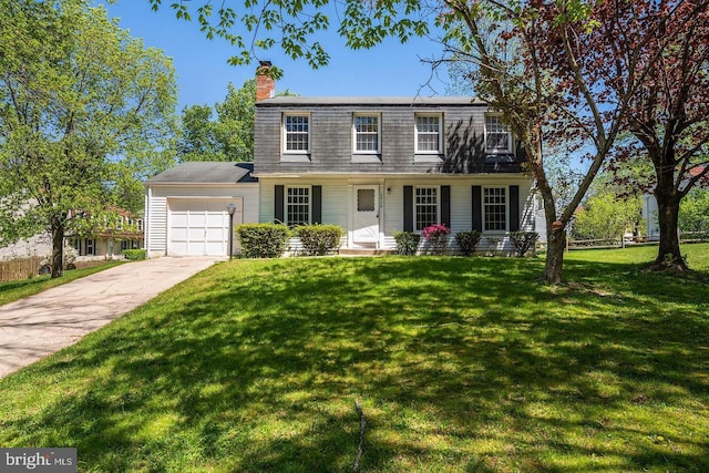 colonial home featuring a front yard and a garage