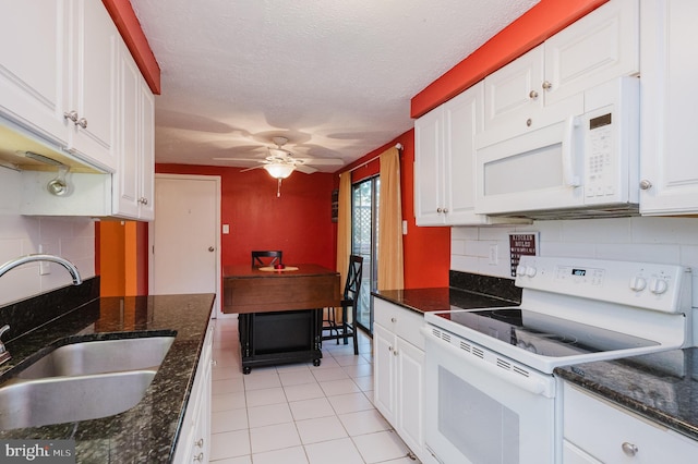 kitchen featuring backsplash, sink, white cabinets, a textured ceiling, and white appliances