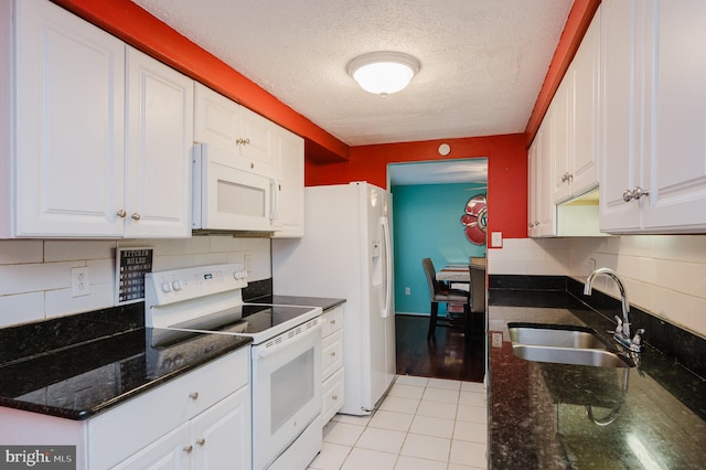 kitchen with sink, light tile patterned floors, white cabinetry, a textured ceiling, and white appliances