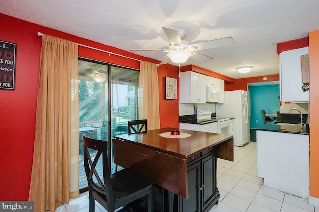 kitchen featuring sink, white cabinetry, a textured ceiling, white appliances, and ceiling fan