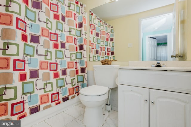 bathroom featuring vanity, toilet, and a shower with shower curtain