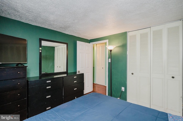 bedroom with a closet and a textured ceiling