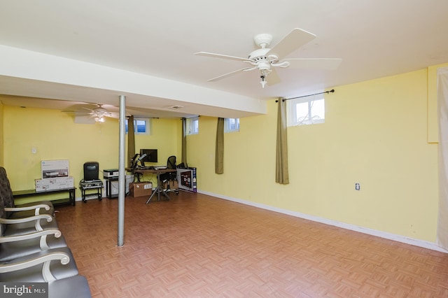 basement featuring parquet floors and ceiling fan