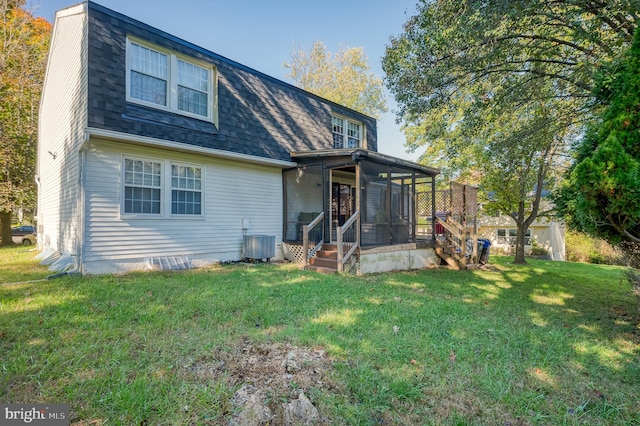 rear view of house with a yard, a sunroom, and central AC