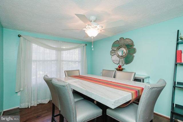 dining area with dark hardwood / wood-style floors, a textured ceiling, and ceiling fan